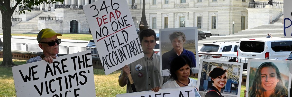 Families of Boeing crash victims hold signs outside the U.S. Capitol 